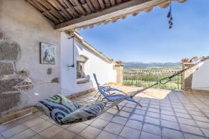 a hammock on the patio of a house at Les Orenetes in Artesa de Segre
