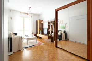 Una sala de estar con un gran espejo y una sala de estar. en El balcón de San Antón by Clabao, en Pamplona