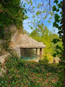 a house with a thatched roof in a garden at Coto del Valle de Cazorla in Cazorla