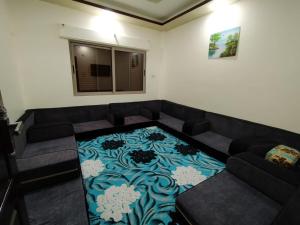 a living room with a couch and a carpet at زريقات للشقق المفروشه in Irbid