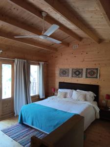 a bedroom with a large bed with a wooden ceiling at Cabanas de Melides in Melides