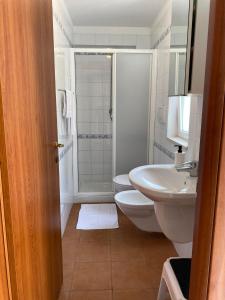 a bathroom with a toilet and a sink and a shower at Villini Frutteto in Castellaneta Marina 