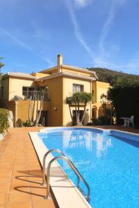 a large swimming pool in front of a house at Casa das Oliveiras - OLIVE TREE in Monchique