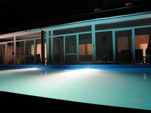 a view of a building at night with blue lights at Tóparti Apartmanház in Balatonszárszó