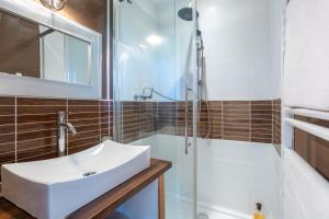 a bathroom with a sink and a shower at La bonne descente in Fouesnant