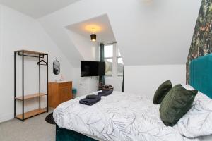 a bedroom with a bed and a television in it at Carlton Hotel in Forres