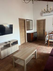 a living room with a coffee table and a tv at Casa dos Sapos in Mértola +8 photos