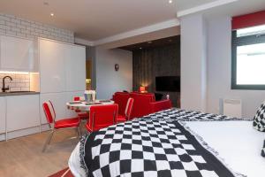a bedroom with a checkered bed and a table and chairs at PALM TREE HOUSE - DINER in Orpington