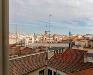 a view of a city from the roofs of buildings at Hostal Josefina-Gran Vía in Madrid