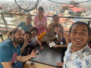 a group of people posing for a picture on a roller coaster at Planet Nomad Hostel in Kathmandu