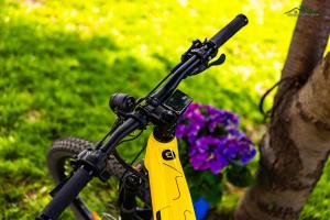 a bike with a yellow handle bar and some flowers at Докторската къща in Sapareva Banya