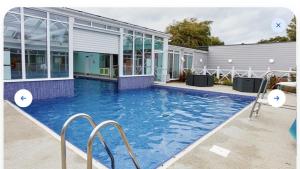 a swimming pool in front of a building at Cozy Hunstanton caravan sleeps 8 pets go free in Hunstanton