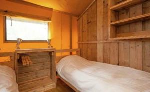 a bedroom with two bunk beds and a window at Veluwe Luxe Glamping In de natuur voor 6 personen LL94 in Putten +38 photos