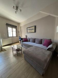 a living room with a couch and a table at Old Town Home Ioannina in Ioannina +2 photos