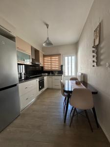 a kitchen with a table and chairs in a room at Old Town Home Ioannina in Ioannina