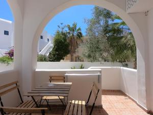 a room with a table and chairs and a window at Anny Studios & Rooms Perissa Beach in Perissa