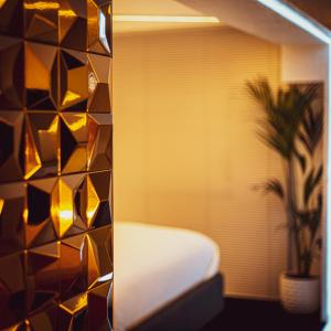 a room with a couch and a window with a plant at Luxury Studio - Manchester City Centre in Manchester