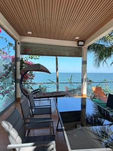a patio with a table and chairs and the ocean at Trị An Villa in Xã Trảng Bôm