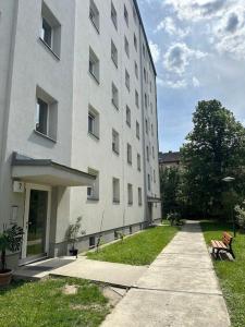a large white building with a bench next to it at Quiet Apartment near Airport Vienna in Schwechat