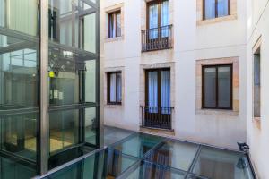 an external view of a building with glass windows at Hotel del Mar in Barcelona