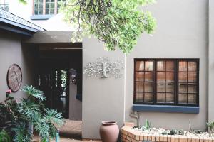 a house with a vase in front of a door at The Red door in Rustenburg