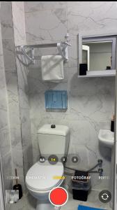 a bathroom with a white toilet and a sink at Alha apart otel in Istanbul