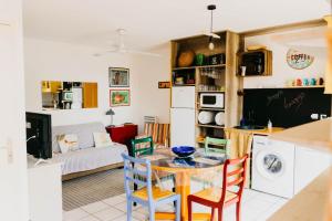 a kitchen and living room with a table and chairs at Le Racou in Argelès-sur-Mer