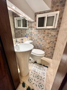 a bathroom with a white toilet and a sink at Luxury New Designer 3 BDRM Entire Home DHA Lahore Near Airport in Lahore