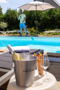 Una botella de vino en un cubo junto a una piscina en Balaton Fantasy Villa, en Balatonfüred