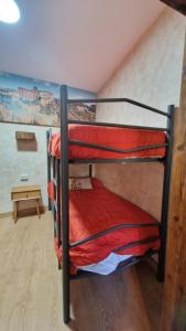 two bunk beds in a room with a table at Apartamento EL TORMO DE CASA BOTES in Cuenca