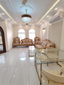 a large living room with couches and a chandelier at Luxury New Designer 3 BDRM Entire Home DHA Lahore Near Airport in Lahore