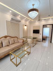 a living room with a couch and a table at Luxury New Designer 3 BDRM Entire Home DHA Lahore Near Airport in Lahore