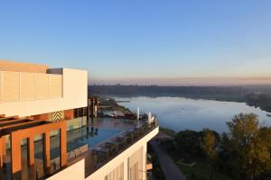 a building with a view of a body of water at Novotel Lubumbashi in Lubumbashi