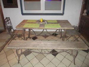 een houten tafel met een bank en een kaars erop bij Große Ferienwohnung in Medebach mit Großer Terrasse in Medebach