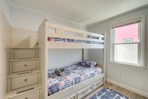 a bedroom with bunk beds and a window at Updated Kitty Hawk Semi-Oceanfront with Ocean Views in Kitty Hawk