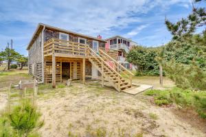 a house with a wooden staircase in front of it at Updated Kitty Hawk Semi-Oceanfront with Ocean Views in Kitty Hawk