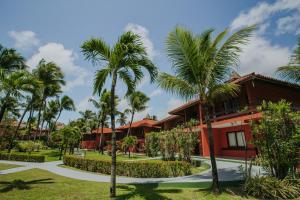 a resort with palm trees in front of it at Pousada Tabapitanga in Porto De Galinhas