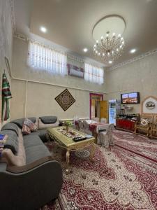 a living room with a couch and a table at Khiva Rajab Ota in Khiva +41 photos