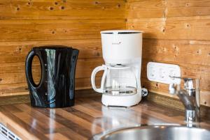 a coffee maker sitting on a counter next to a sink at Lillis Ferienhaus Nr 27 in Göhren