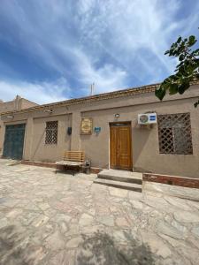 a building with a bench in front of it at Khiva Rajab Ota in Khiva