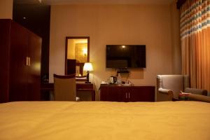 Letto o letti in una camera di RATNA HOTEL