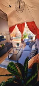 a living room with couches and a table in a tent at Glamping Tajemniczy Ogród in Strzelin