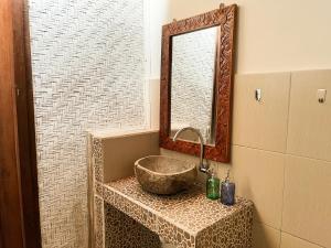 a bathroom with a sink and a mirror at Little Bear Bungalows in Gili Air