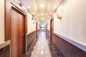 a corridor of a hallway with a long hallway at FabHotel Grand Falcon in Bangalore