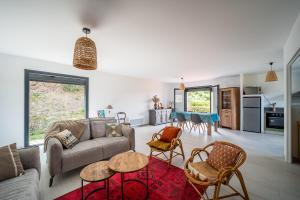 a living room with a couch and chairs at Maison Le Boulou - Grand jardin piscine privée in Le Boulou