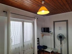 a room with two windows and a ceiling with a light at Adamas Bed & Breakfast in Ponta Delgada +56 photos