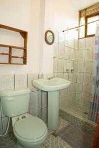 a bathroom with a toilet and a sink at Bed and Breakfast Puerto López in Puerto López +145 photos