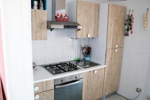 a small kitchen with a stove and a sink at SaMi house - fronte mare del Salento in San Foca
