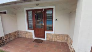 a front door of a house with a tiled floor at The Dunes Studio 11 in Plettenberg Bay +8 photos
