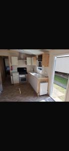 a small kitchen with a sink and a stove at Paradise Holiday home in Lytchett Minster